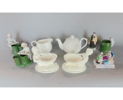 A pair of Royal Worcester white glazed sweet meat dishes in the form of cherubs, both with green printed marks to base, no 34