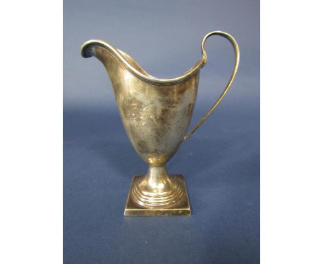 Georgian style silver helmet shaped cream jug, with C scroll handle, stepped square base, maker marks worn, Birmingham 1909, 