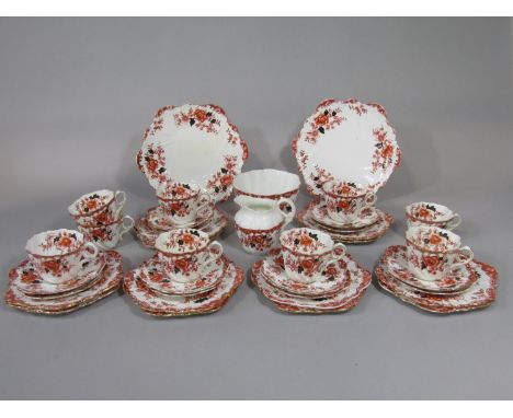 A collection of Edwardian Paragon china tea wares of wrythen form, comprising milk jug, slop bowl, pair of cake plates, nine 