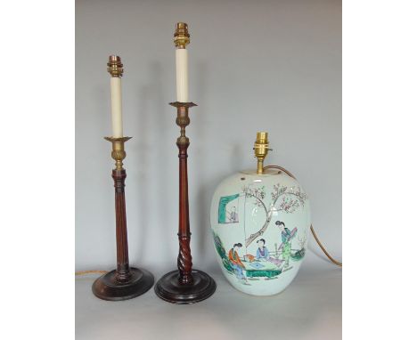 Two similar mahogany candlestick type table lamps with gilt cast metal sconces, the largest 57cm high, together with a furthe