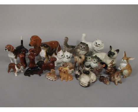 A collection of Beswick ceramic cats, dogs and other animals including Siamese cat 1559, two Siamese kittens 1296, long furre