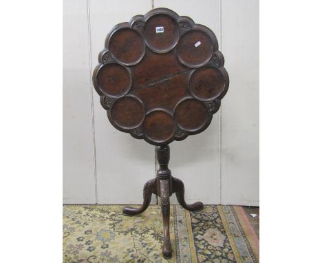 A Georgian style oak snap top supper table with dished and moulded surround and repeating carved floral detail raised on a tu