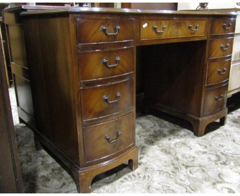 A reproduction Georgian style kneehole twin pedestal writing desk (one piece) with inset triple leather panelled top over an 