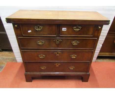 An 18th century style walnut veneered fold over top bachelors chest of two short over three long graduated oak lined drawers 