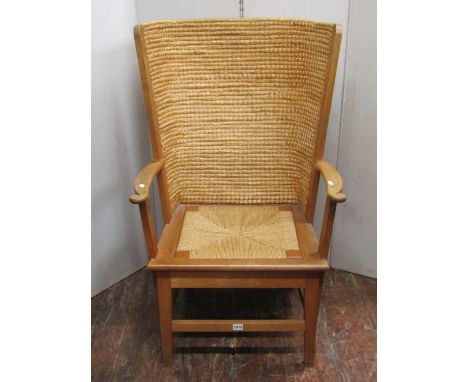 A traditional Orkney chair with light oak frame and drop in rush seat, stamped to internal seat rail D M Kirkness, Orkney, ma