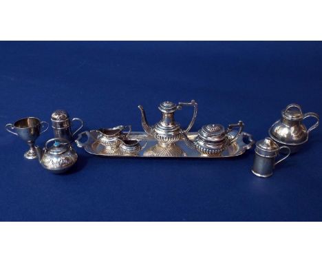 Miniature Regency style boat shaped silver tea service comprising teapot, water pot, milk jug, sucrier and twin handled tea t