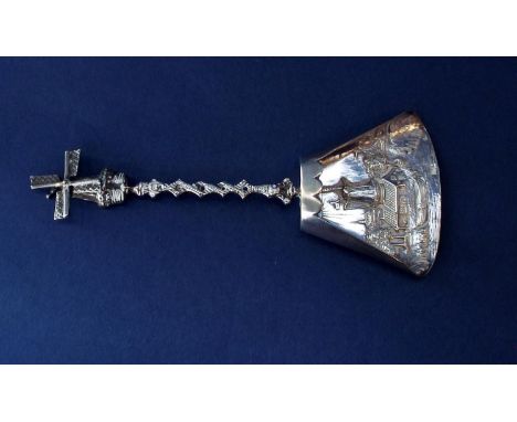 A Dutch novelty sugar spoon/caddy spoon, the knop mounted by a windmill with articulated blades over a bowl with embossed det