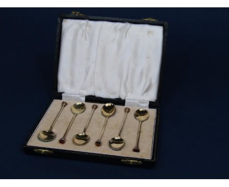 Good cased set of six silver gilt knop end coffee spoons with guilloche enamel decoration to the back of each spoon, maker Wi