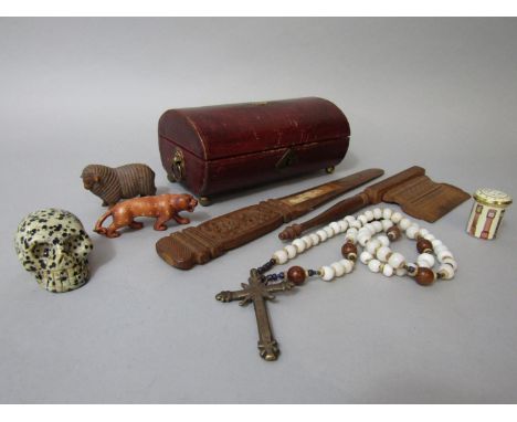 A small sandalwood netsuke of a sheep in full fleece, a carved jasper skull, a sandalwood with carved detail, a small Regency