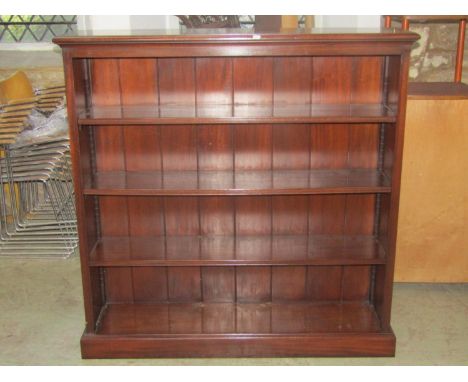 A good quality reproduction mahogany floorstanding open bookcase with three adjustable shelves raised on a fixed moulded plin