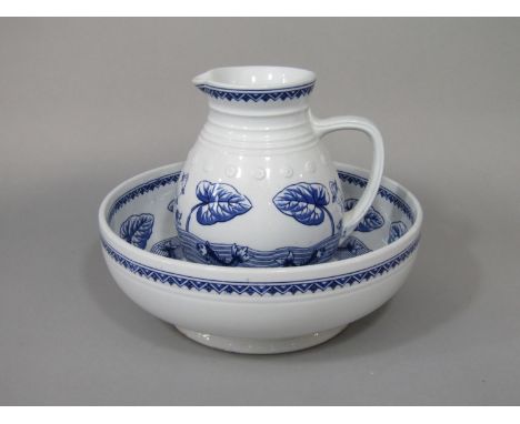 A late 19th century Copeland aesthetic movement jug and basin set with blue printed decoration of stylised leaping and swimmi