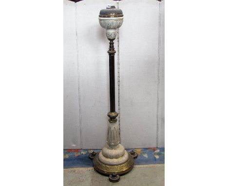 A good quality Victorian floor standing cast brass and ceramic telescopic oil lamp standard, with embossed foliate detail 