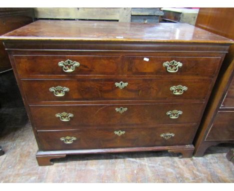 A Georgian figured walnut veneered bedroom chest with herringbone crossbanding and fitted with two short over three long grad
