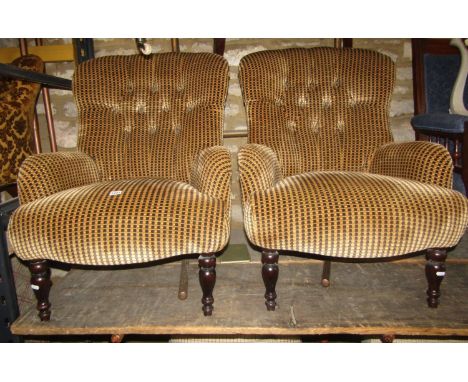A pair of contemporary Victorian style low button back drawing room chairs with repeating patterned upholstery and tapered fo