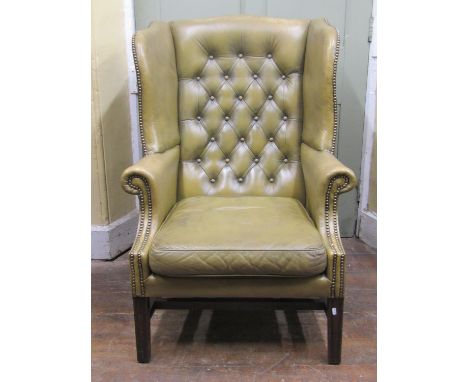 Two similar good quality Georgian style olive/sage green leather upholstered wing armchairs with brass studded detail, one wi