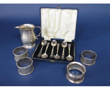 A mixed collection of silver comprising a baluster cream jug on stepped circular base, four silver napkin rings, a cased set 