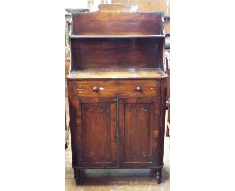 A small Regency rosewood chiffonier, the raised open shelf with shaped outline and inlaid brass foliate detail over a frieze 