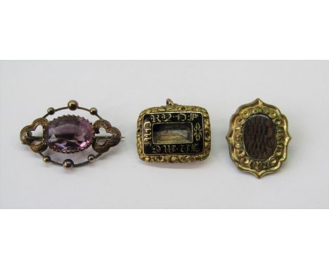 Three antique yellow metal brooches; a beaded example set with an amethyst, a Georgian mourning example with black enamel dec