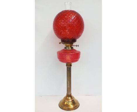 Large brass bass oil lamp with cranberry glass shade and reservoir 70cm