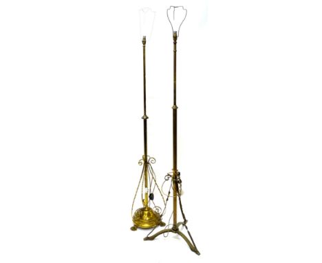 An early 20thC brass adjustable standard lamp, with a circular base and paw feet and an early 20thC cast and wrought brass ad