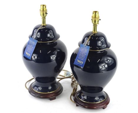 A pair of Wade ceramic table lamps, each with a deep blue glaze and hardwood stand, original labels and unused, 43cm H.