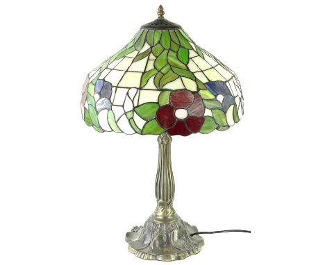 A modern Tiffany style lamp, the stained glass shade, decorated with flowers, leaves, etc., on a metallic base, 63cm H.