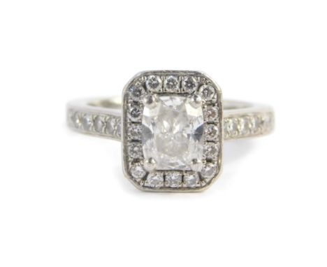 An exceptional platinum set diamond halo style engagement ring, set with central cushion cut diamond, certified with GIA cert