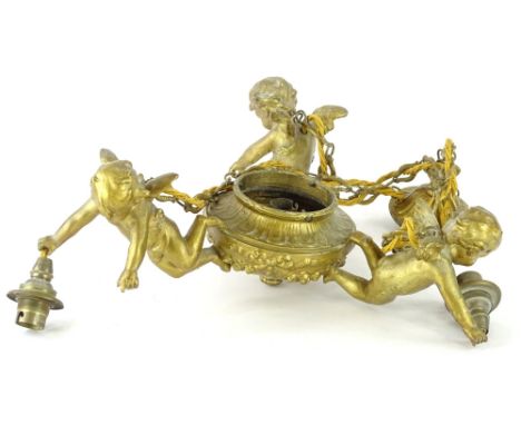 A gilt metal ceiling light, modelled in the form of three putto, around a central urn, 38cm W.