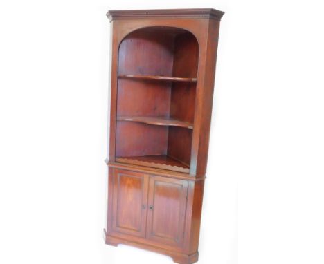 A 19thC mahogany corner cabinet, the top with a dental cornice above two open and shaped shelves, the base with two panel doo