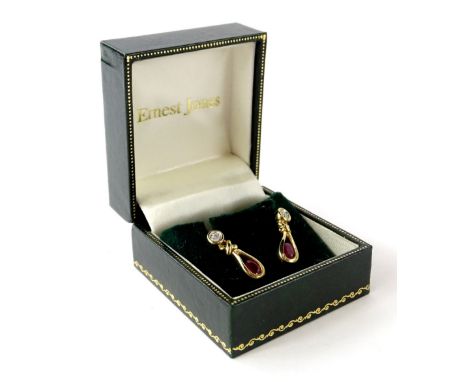 A pair of 9ct gold ruby and diamond earrings, with oval facet cut rubies in tension setting, and with illusion set tiny diamo