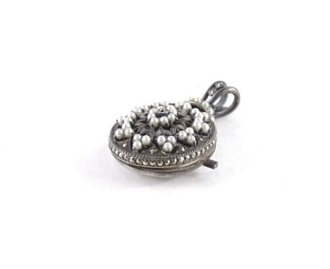 A seed pearl and marcasite set locket pendant, the central floral design with sprays of seed pearl, in silver plated frame, 4