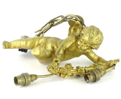 A gilt metal ceiling light, modelled in the form of a putto with a flower, swag and two brass fittings, 32cm W.