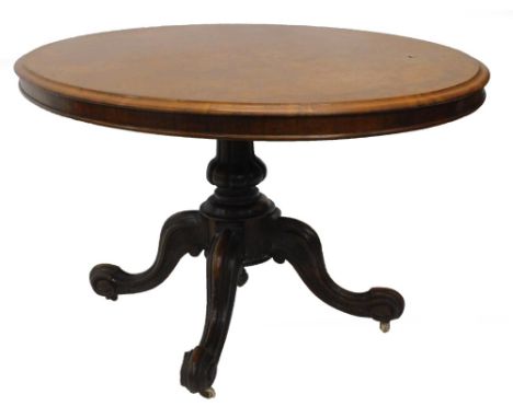 A Victorian walnut and burr walnut oval breakfast table, the quarter veneered top with a moulded edge on a turned column and 