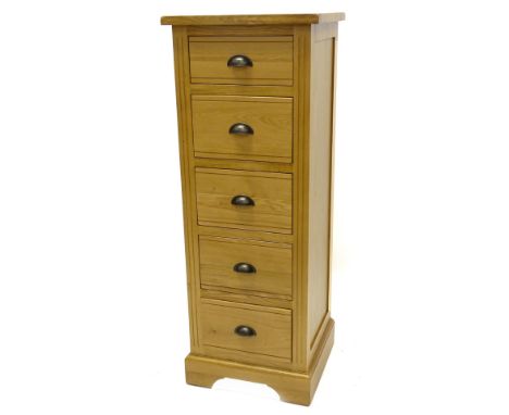 An ex shop display Hampton Court oak narrow chest of five drawers, with bronzed metal handles, on bracket feet, 126cm H, 47cm