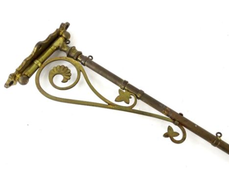 A Victorian gothic style lacquered brass wall mounted bracket, probably for a face screen or similar, 98cm L.