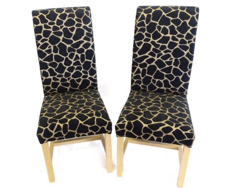 A pair of ex display floor beech dining chairs, each upholstered in leopard print type fabric, on plain legs with H stretcher