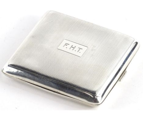 A George V engine turned silver square cigarette case, engraved with initials F.H.T, Birmingham 1928.