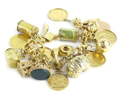 A gold charm bracelet, with twenty charms, with fancy filed figure eight link charm bracelet, yellow metal, tests as 18ct, th