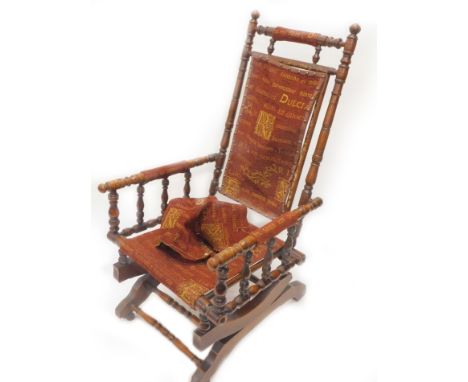 An American type turn walnut rocking chair, upholstered in red fabric on ceramic castors.