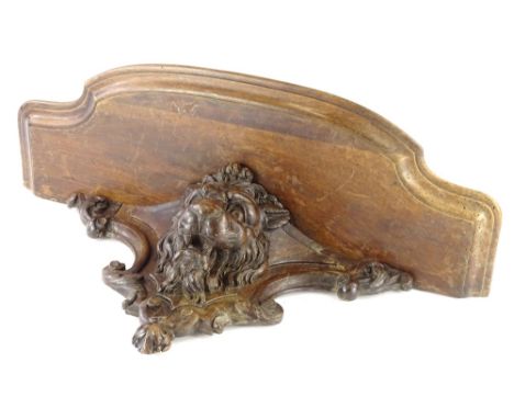 A Victorian walnut wall bracket, carved with a lion, with a moulded shaped shelf, 62cm W.