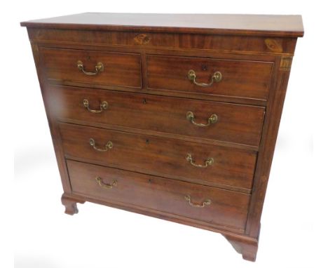 An early 19thC mahogany chest of drawers, the rectangular top above a frieze inlaid with shells, etc., and two short and thre