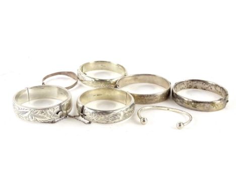 Seven silver bangles, to include four Victorian hinged bangles, (AF), a child's silver bangle, a child's silver talk bangle, 