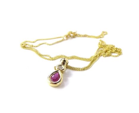A 9ct gold pendant and chain, of elongated form set with oval faceted ruby and round brilliant cut diamond, on a fine link ch