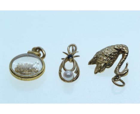 9ct gold swan charm and a 9ct gold, cultured pearl & sapphire pendant, gross weight 2 grams, together with a yellow metal 'go