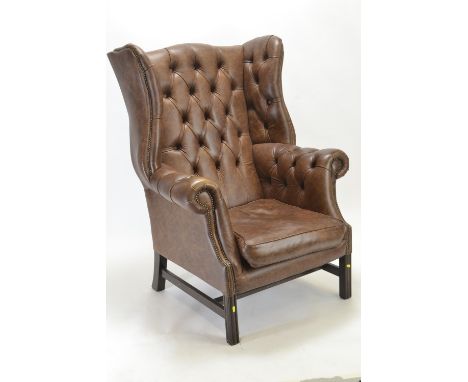 Brown leather fireside armchair, with button back and rolled arms 