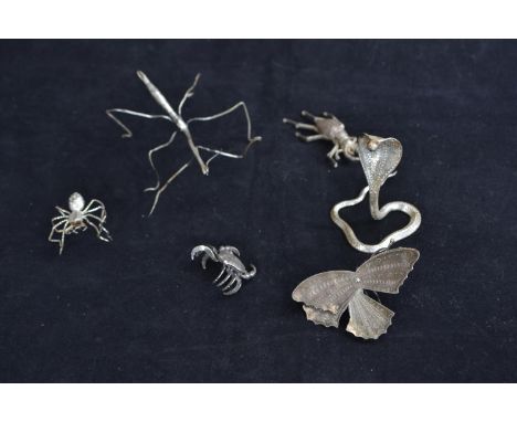 Six intricately detailed white metal creatures including; moth, spider, stick insect, crab, cobra and beetle, tallest approx.