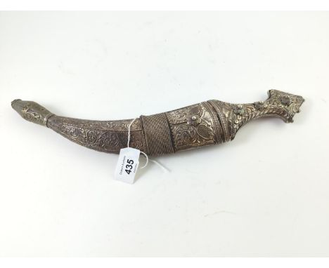 An antique curved middle eastern jambiya dagger, with decorative white metal blade, handle and scabbard, length of blade 18cm