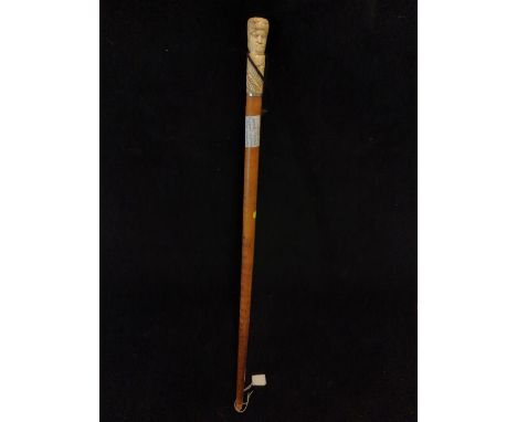 Antique walking stick with carved bone handle and white metal banding 