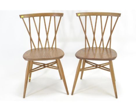 2 Ercol 376 Windsor chairs, in beech & elm. Vintage blue label.Small split to rear of seat on 1 chair, small split in spindle