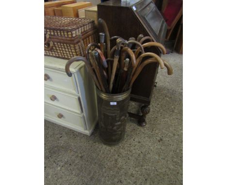 PRESSED BRASS STICK STAND WITH A QUANTITY OF MIXED WALKING STICKS TO INCLUDE TREEN STICKS, SILVER TOPPED STICK ETC (QTY)   